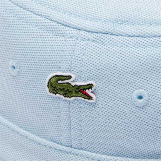 Шапки с козирка Lacoste Рибарска Шапка Bucket Hat Sn52 Светлосин Lacoste Рибарска Шапка Bucket Hat Sn52 Светлосин Шапки с козирка