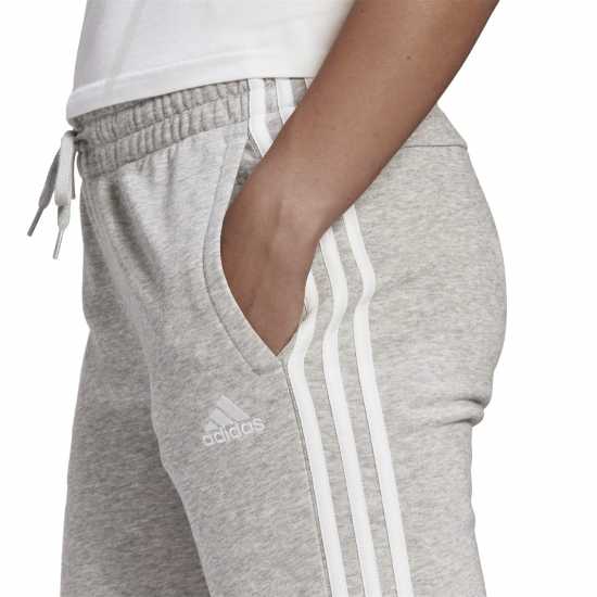 Дамски долнища на анцуг Adidas Essentials 3-Stripes Pants Slim Womens Средно сиво Adidas Essentials 3-Stripes Pants Slim Womens Средно сиво Дамски долнища на анцуг